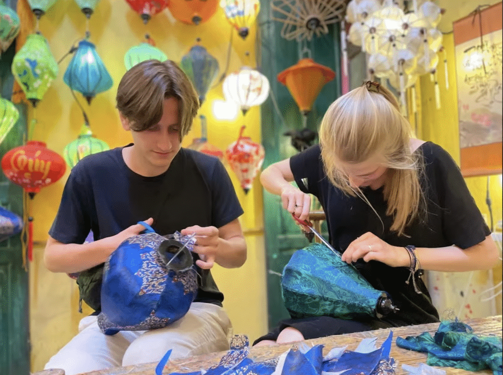 a young couple making lanterns in hoi an vietnam a young couple making lanterns in hoi an vietnam